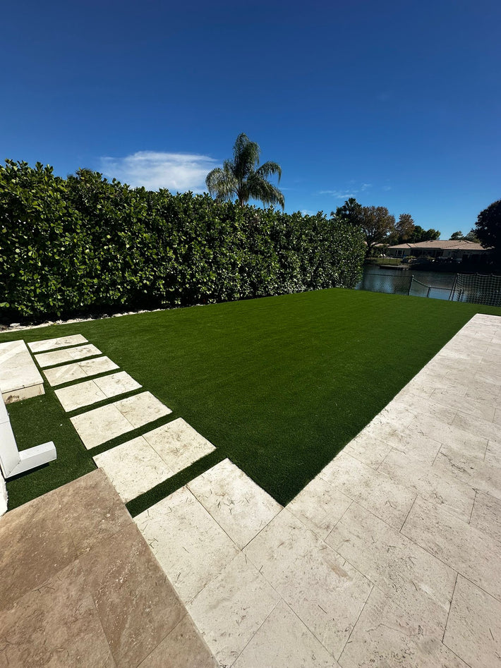 Backyard patio enhanced with artificial turf for added comfort and greenery in Miami