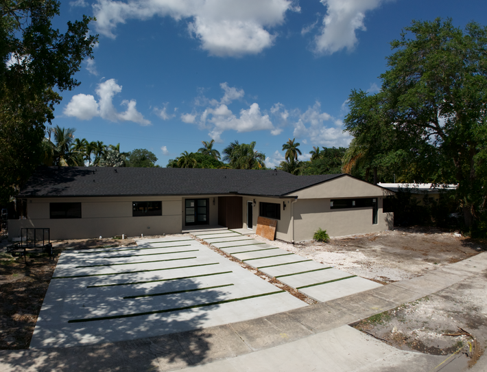 Decorative concrete driveway with exposed aggregate finish in a Miami residential home