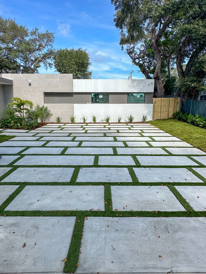  Driveway with artificial grass strips installed for a unique and eco-friendly design
