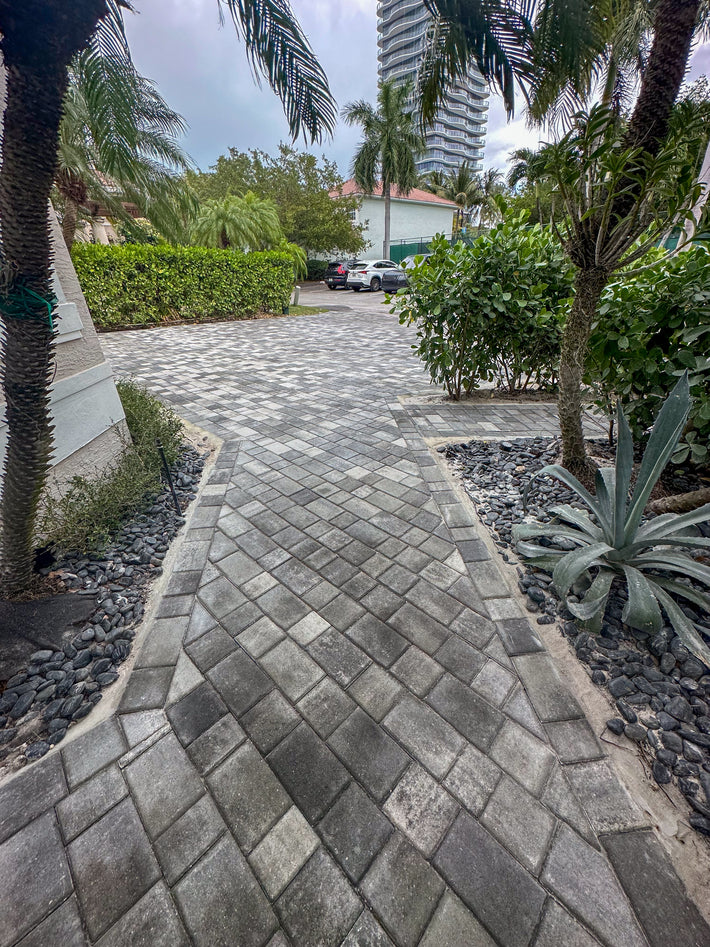 Patterned brick pavers used to create a decorative and durable driveway entrance