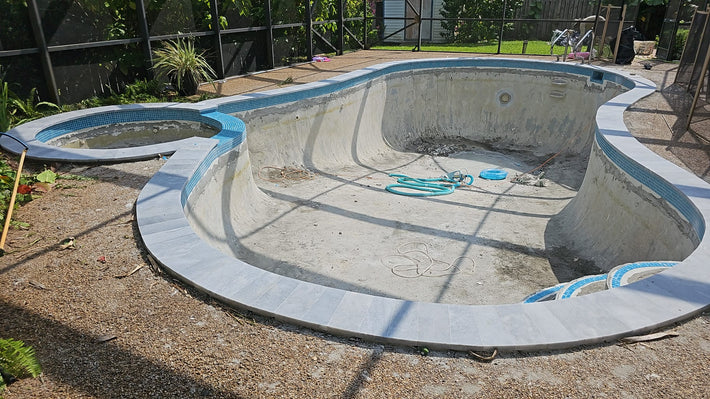 Pool waterline tile cleaned and reinstalled for a fresh and appealing appearance

