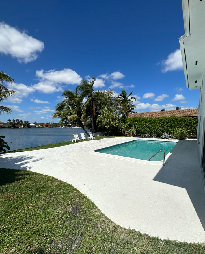 Residential plain concrete deck installed to expand usable outdoor space