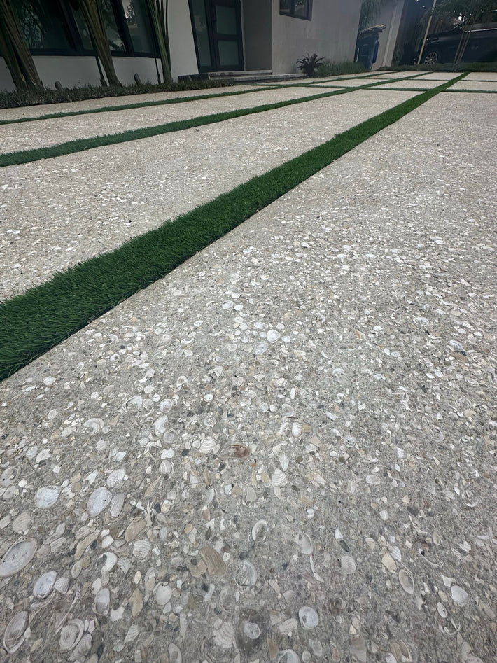 Residential driveway installed with exposed aggregate for added texture and traction