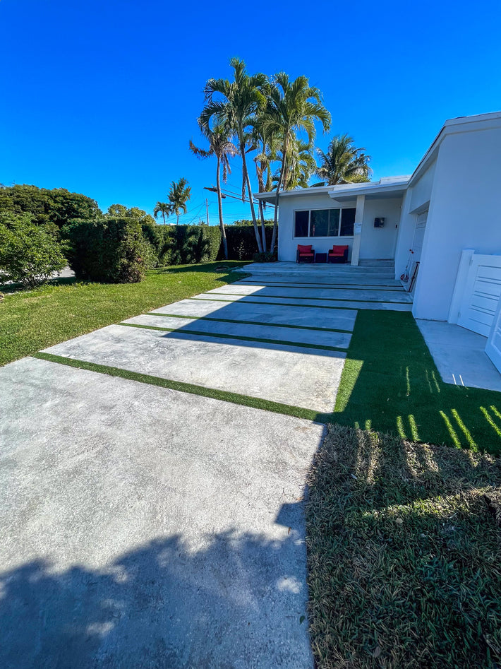 Textured concrete driveway installed with decorative finish for added traction and design